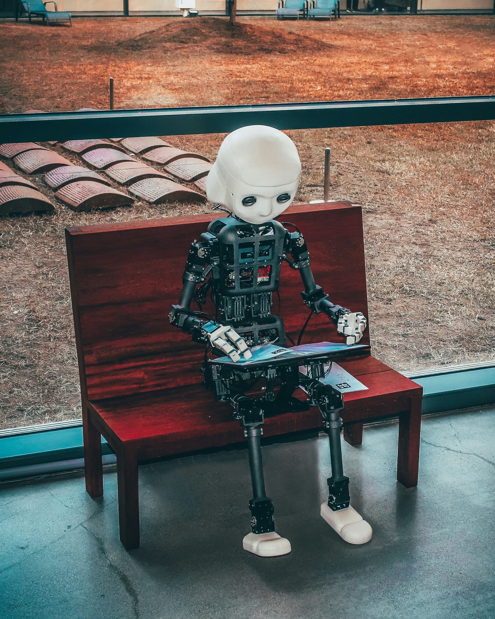 black and white robot black and white robot toy on red wooden table